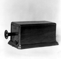 Box telephone with Watson's Thumper. The 1877 telephone had the first signaling device, the Thumper. Before 1878 there were no central offices, and the line between two phones was always open. You could shout Ahoy! to attract the attention of the party being called or thump the diaphragm inside the mouthpiece with a pencil. Thomas Watson, Bell's telephone designer and engineer, soon realized that he'd have to modify this, because the diaphragms were being broken by this abuse. He mounted a small hammer in the box phone, which would strike the edge of diaphragm. It was activated by a knob outside the box. (THG file photo).